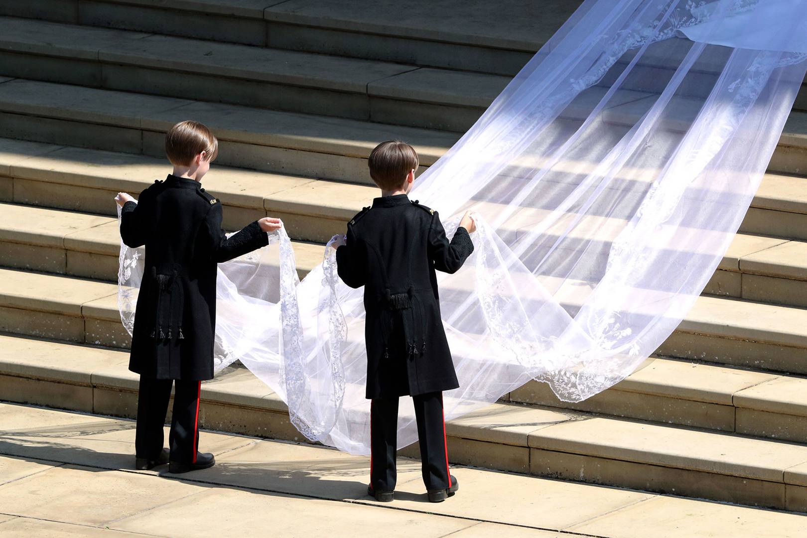 Meghan's wedding veil being carried by her two page boys