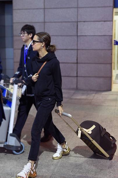 Alicia Vikander pairs Louis Vuitton’s Archlight trainers with its knitted carry-on.